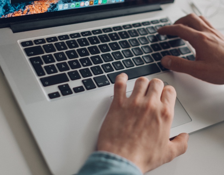 Background image - hands typing on keyboard